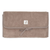 Tapis à langer nomade en tissu côtelé taupe avec intérieur feuillage. Léger, pliable et pratique avec poches intégrées. Idéal pour les sorties avec bébé.