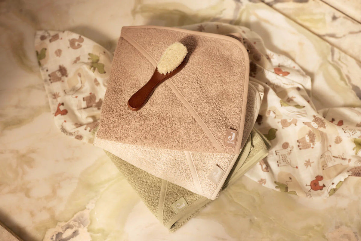 La cape de bain bébé Soft Matcha en éponge 100 % coton enveloppe bébé de douceur après le bain grâce à sa matière absorbante, sa capuche à petites oreilles et son format généreux. Cape de bain bébé en éponge Soft Matcha : une sortie de bain 100 % coton douce, absorbante et confortable avec capuche pour garder bébé bien au chaud.